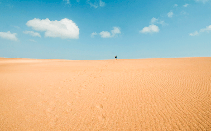 Tourists walking thorugh the endless sand of La Guajira Desert