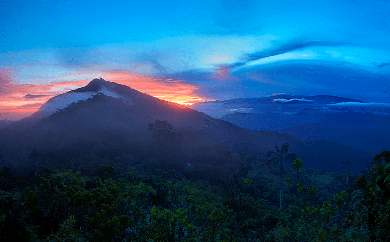 Sunrise through a peak in Sierra Nevada de Santa Marta' mountain range