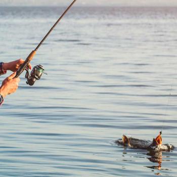 A man practices sport fishing in a lake in Colombia.